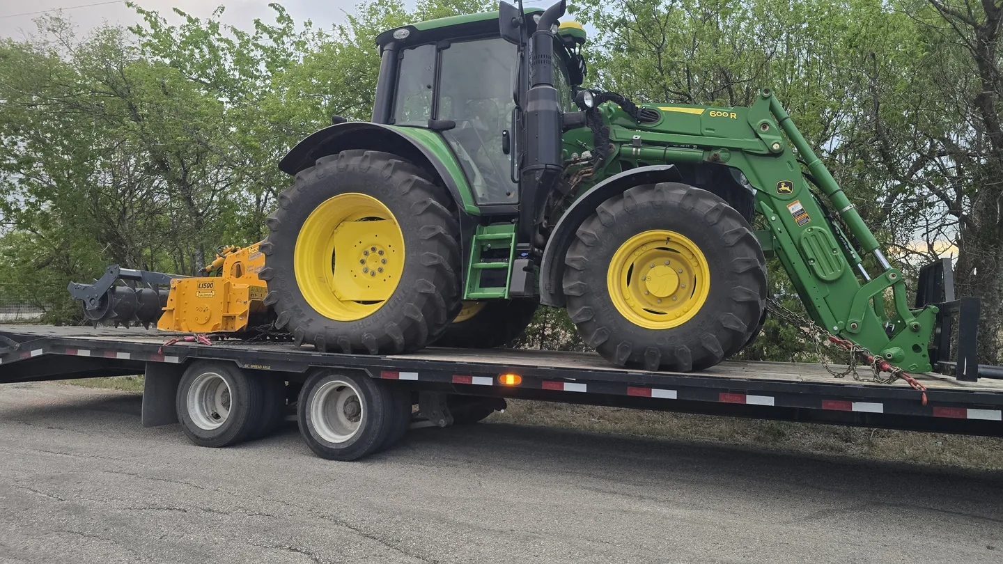 Tractor with a rock mill loaded on a trailer, rock milling equipment